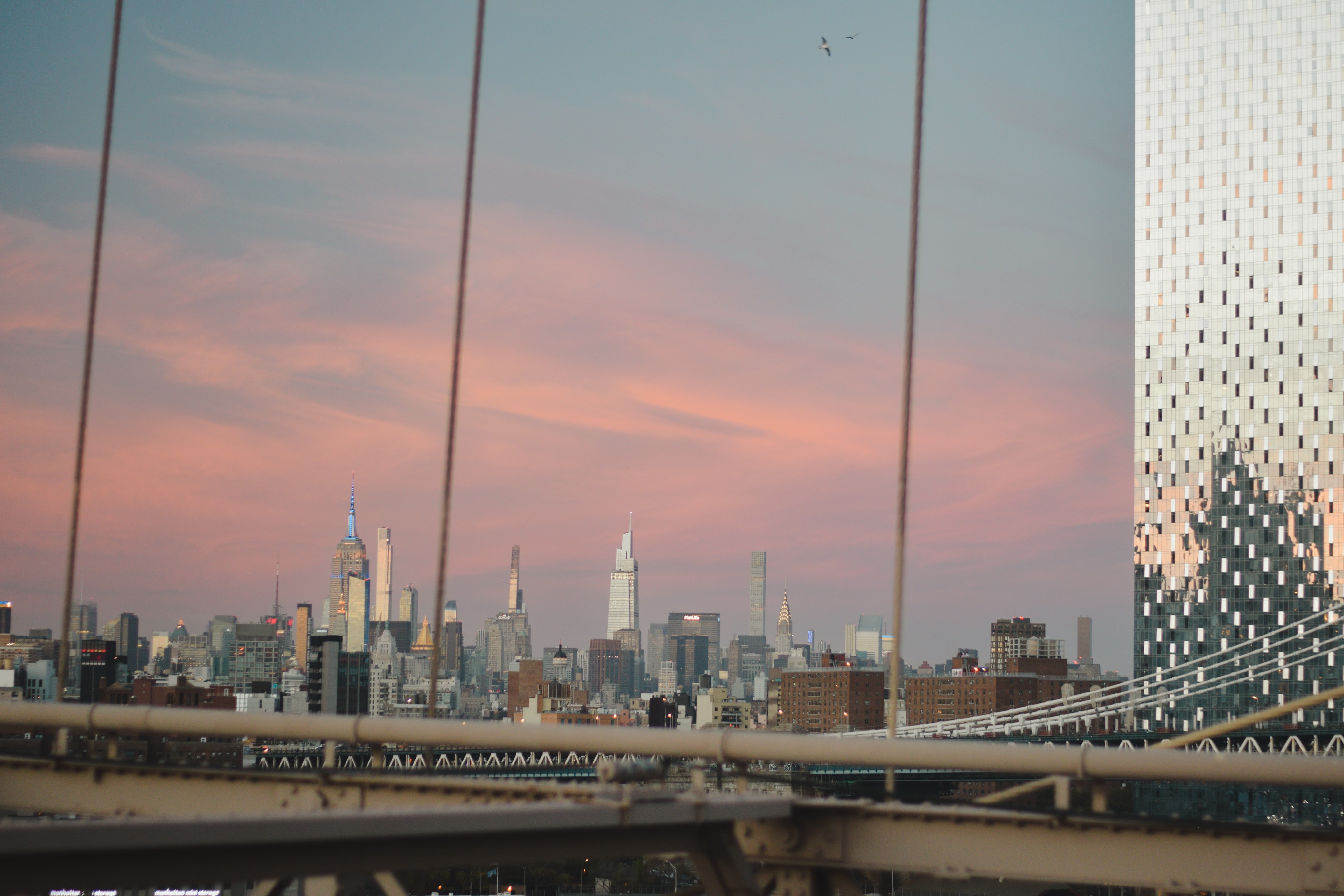 View at sunset of New York skyscrapers from Brooklyn Bridge