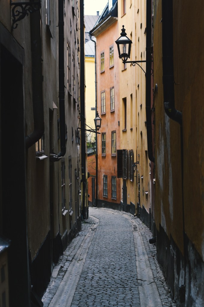 Gamla Stan, old town in Stockholm Sweden, yellow buildings down an alleyway