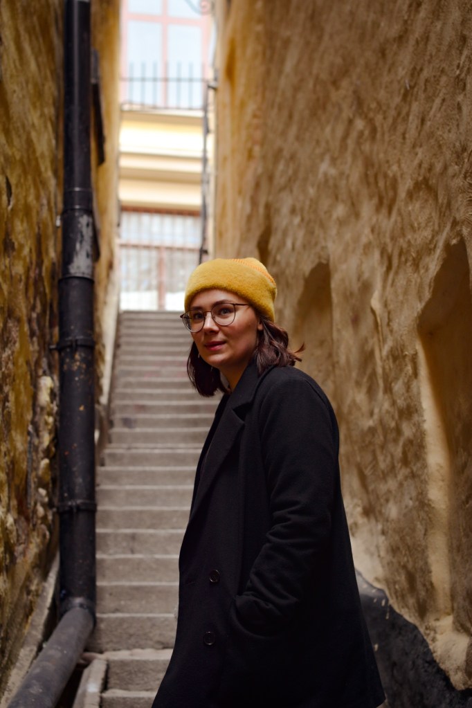 Gamla Stan, old town in Stockholm Sweden, yellow buildings down an alleyway with stairs