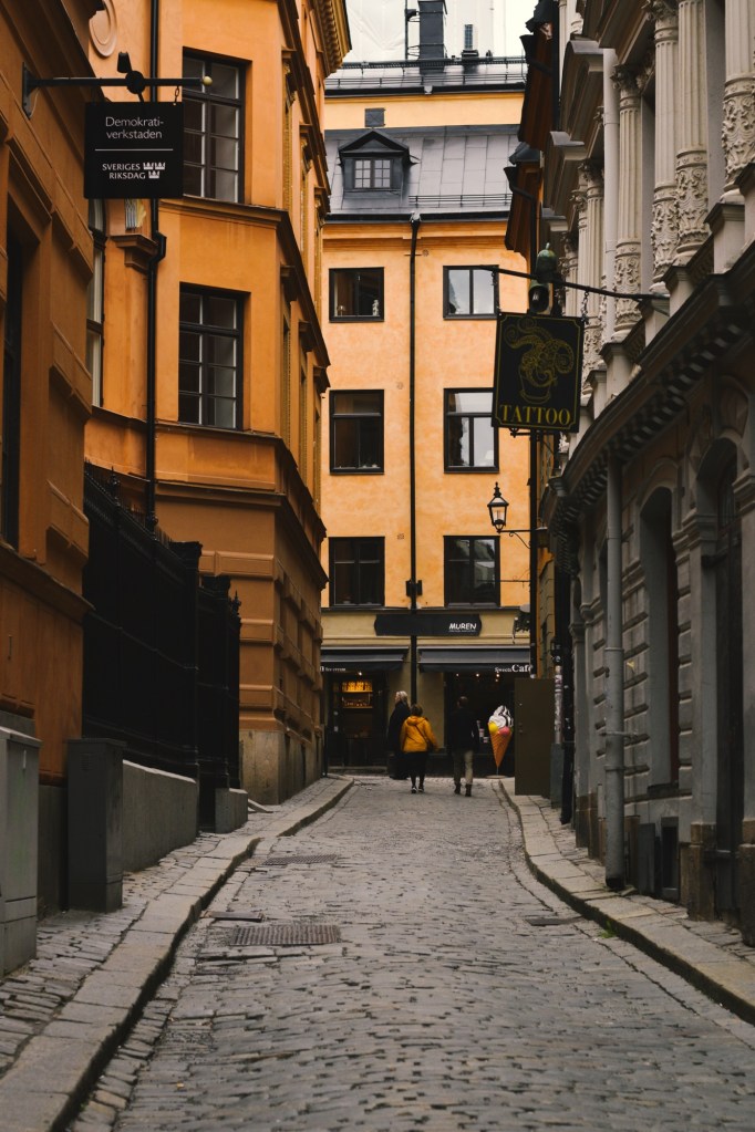 Gamla Stan, old town in Stockholm Sweden, yellow buildings down an alleyway