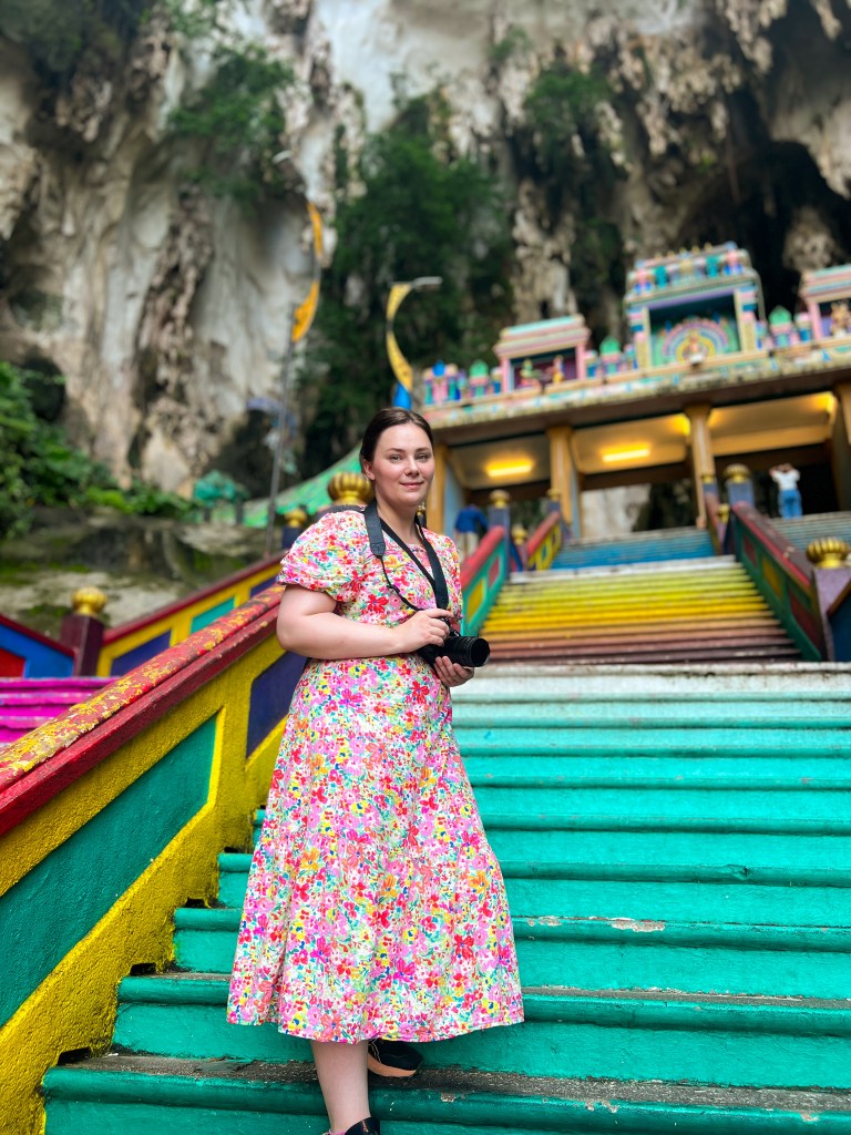 Batu caves colourful stairs with colourful modest dress in Kuala Lumpur, Malaysia