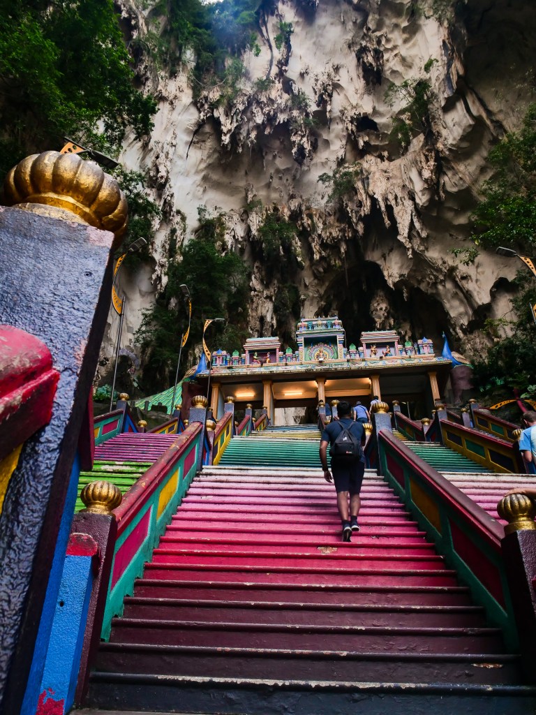 Walking up the colourful stairs at Batu Caves in Kuala Lumpur, Malaysia