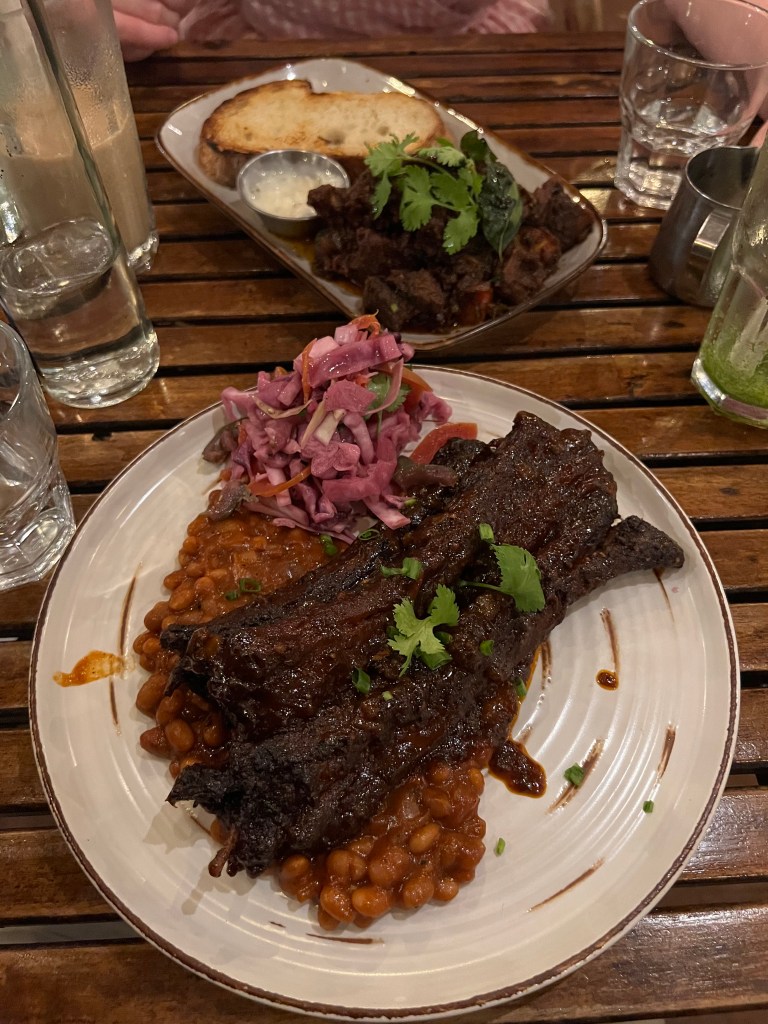 Dry rubbed and smoked pork ribs served with spiced beans and coleslaw at Pandhal