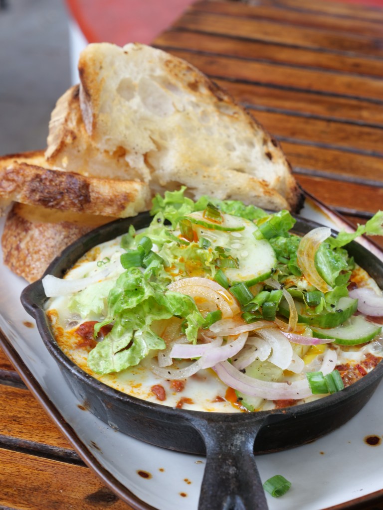 Shakshuka in a cast iron dish with sourdough toast at Pandhal in Firt Kochi, South India