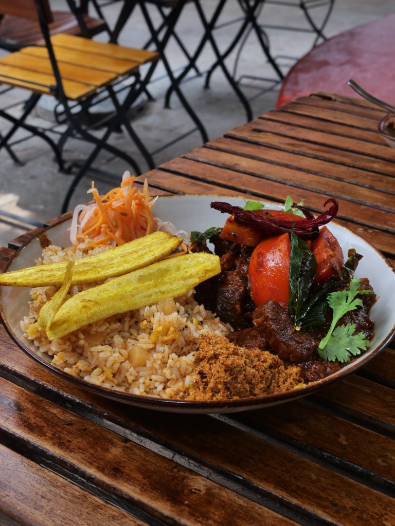 Traditional Kerala Beef curry with rice and plantain chips and salad at Pandhal restaurant, Fort kochi