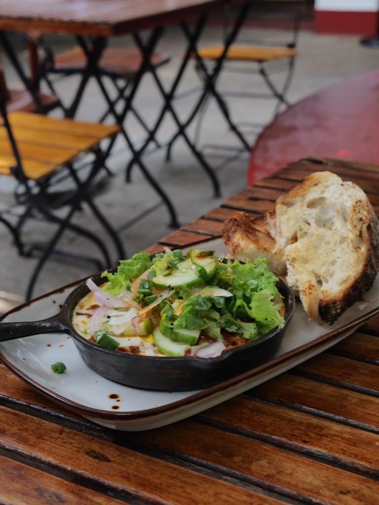 Shakshouka with salad and toasted sourdough at Pandhal restaurant in fort kochi
