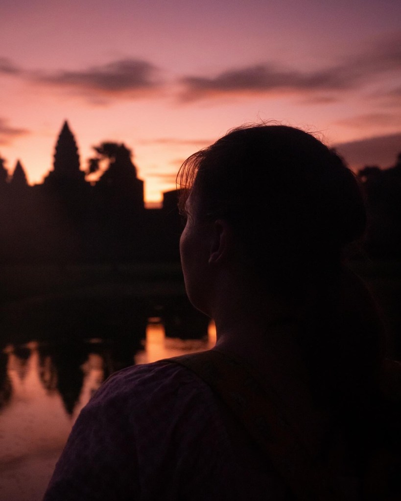 Woman looking out to Angkor Wat, Cambodia, at sunrise