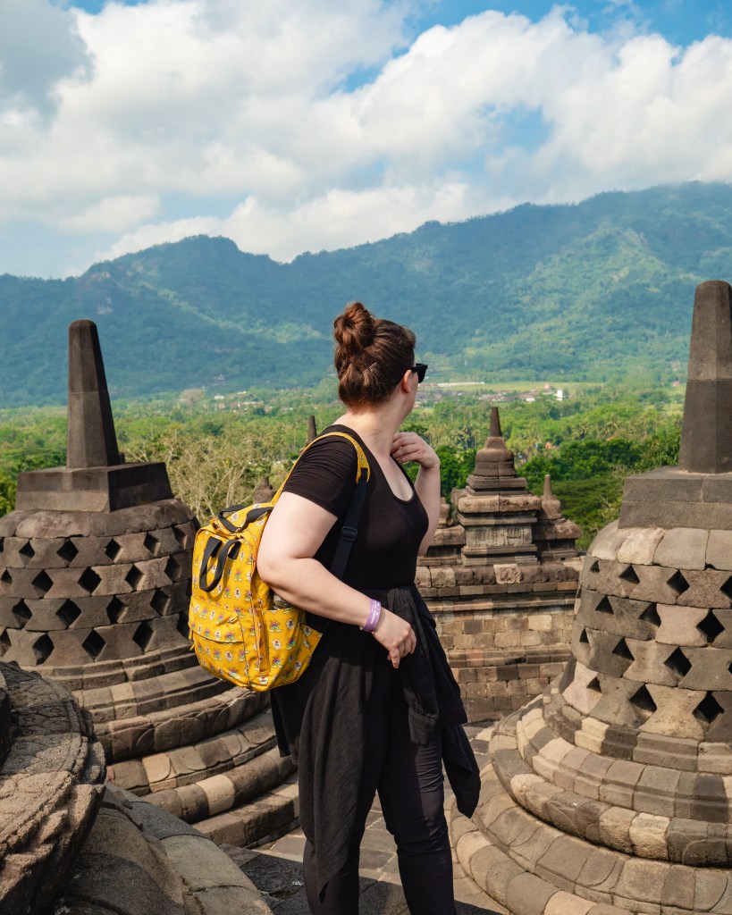 Woman looking out over Buddhist temple in Yogyakarta , Indonesia whilst travelling